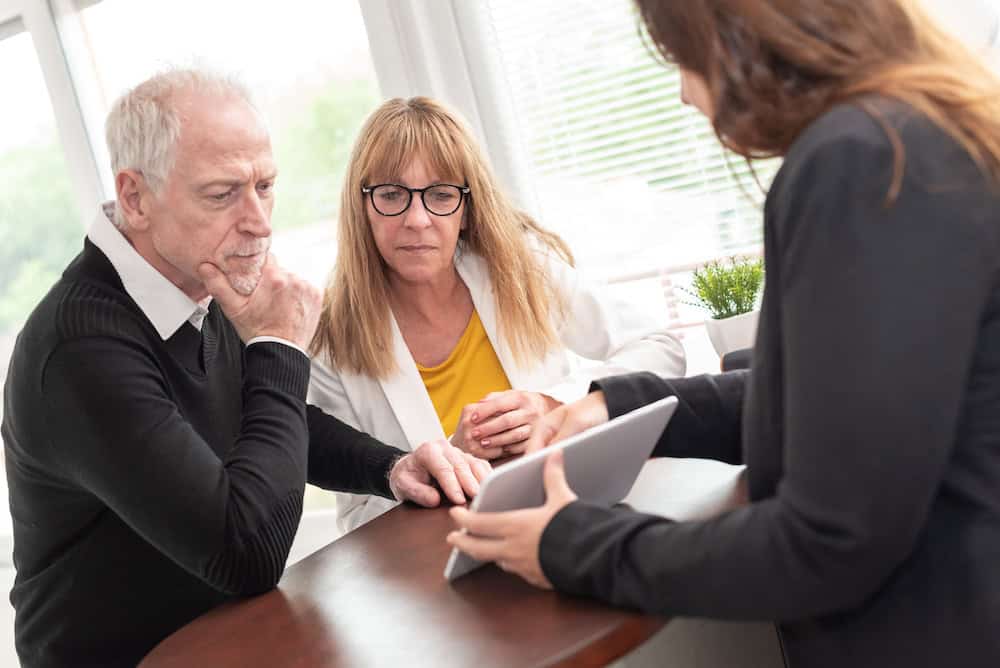 Senior couple meeting financial adviser for investment
