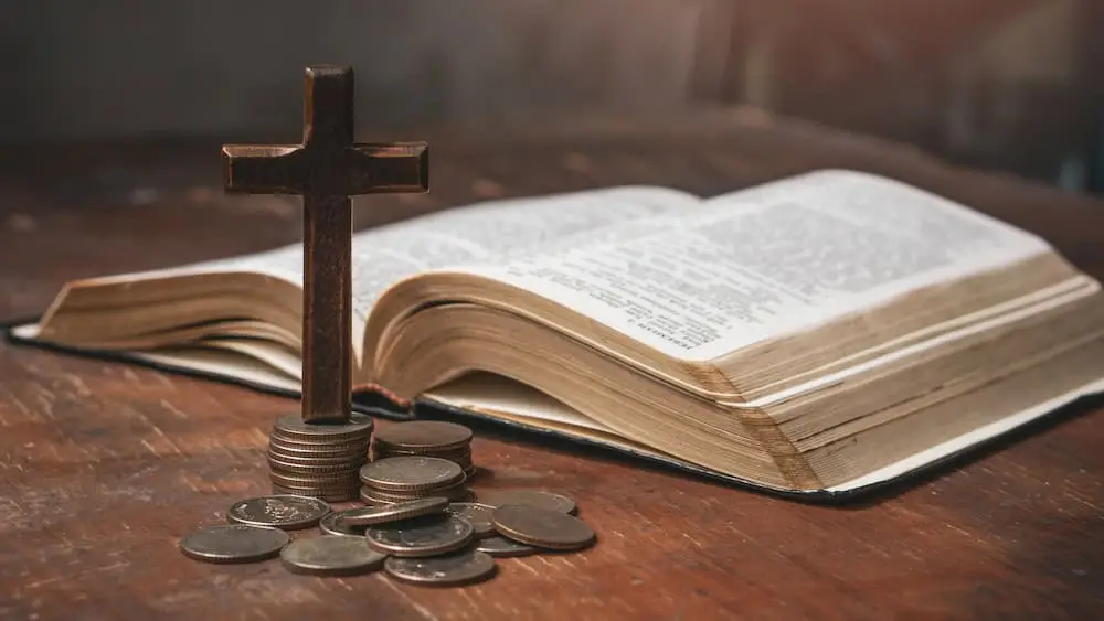 Tithe concept. Cross and coins with Holy Bible. Biblical concept of Christian offering, generosity, and giving tithes in church.